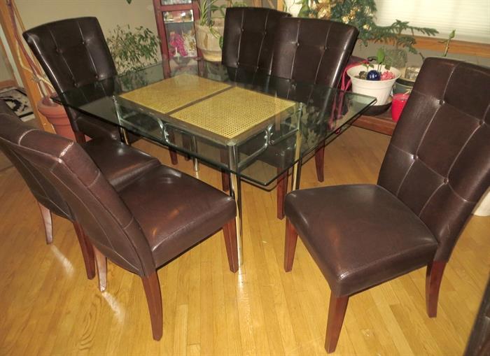 Leather-like parsons chairs. Glass table
