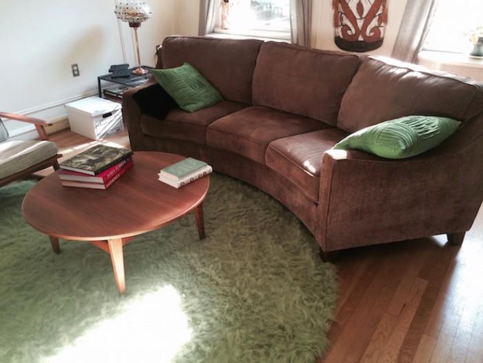 CURVED COUCH, ROUND LIME RUG, THROW PILLOWS