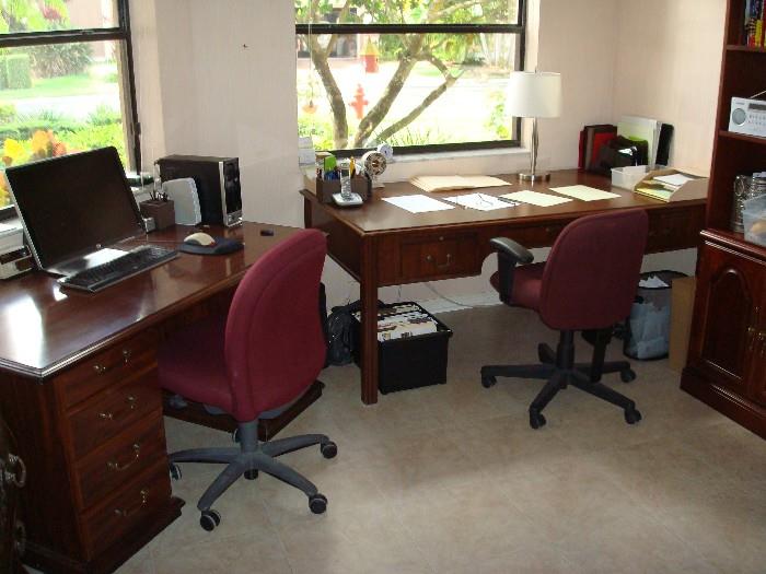 office desks and 2 red upholstered office chairs