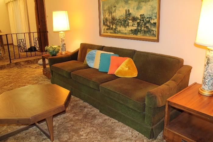 Mid century sofa in a deep green. Some fading but absolutely no rips and it is super clean.