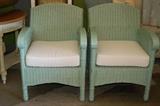 Wicker chairs in Sea green with linen pillow, mahogany arms and legs.