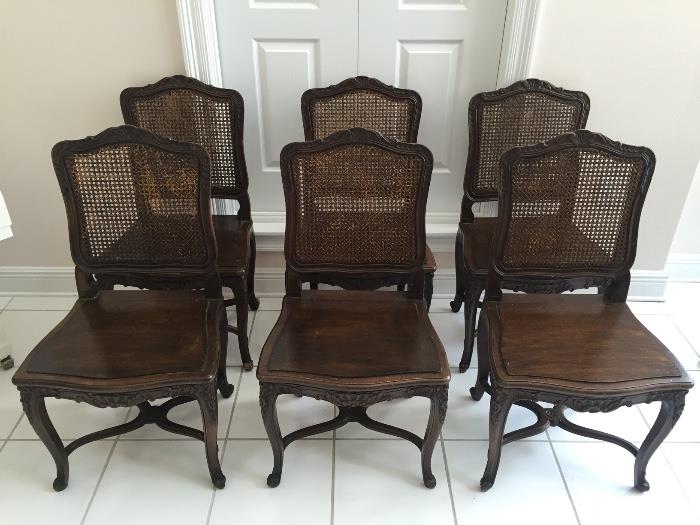 Set of six French Louis XIV cane back dining chairs.