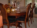 Gorgeous dining table with 6 side, 2 arm chairs, leaf and pads