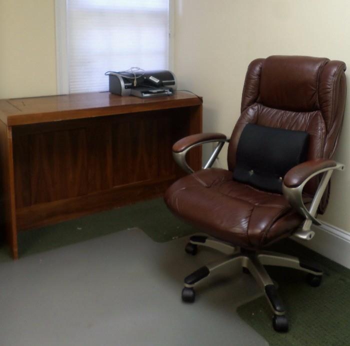 computer work station and a leather desk chair