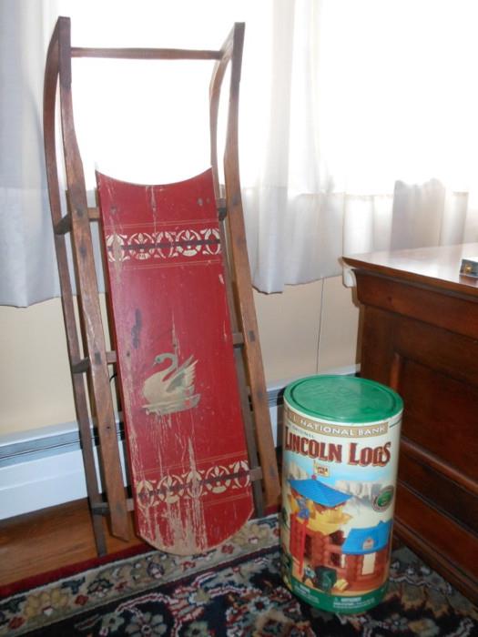 Antique painted sled and vintage Lincoln Logs