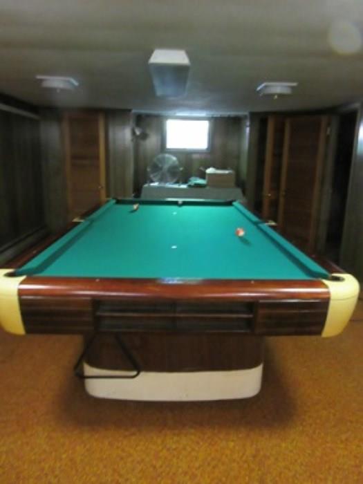 Slate bed Billiard  table.  The table has inlay ivory(?)  and is in good condition.  The table includes balls, 8 que sticks, rack for holding them and the table has leather pockets.