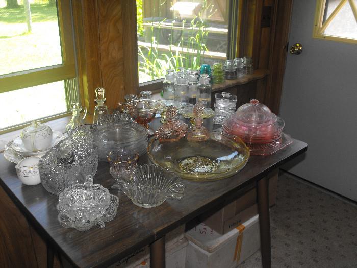 Assortment of glassware including pink & yellow depression glass
