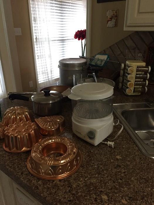 Kitchen items,  steamer, spice rack, pots, metal pans