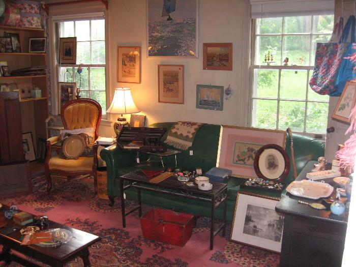 This room is full of posters , old photographs , reproductions of famous art, old photo albums and more 
