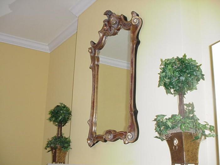 Ornate mirror and topiaries