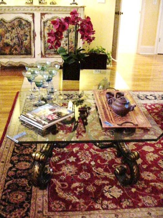 Another view of the living area, table, rug, painted cabinet