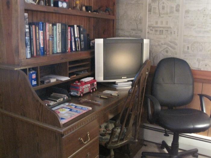 Flatscreen TV, desk and office chair.