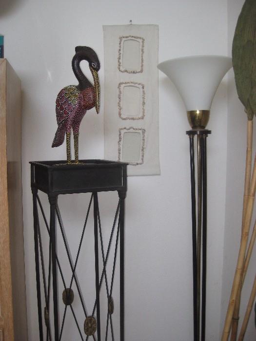 tall metal plant stand, wooden painted sea bird, seashell framed wall hanging