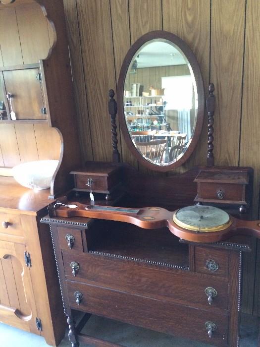          Antique dresser with oval mirror