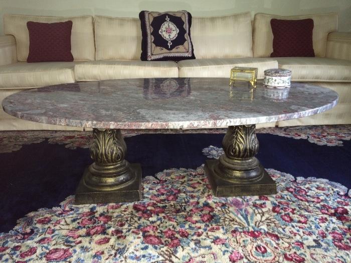 Custom made coffee table with black to white striated marble top above trefoil and gilded wrought iron double pedestal. 16.5" height and 47.5" width.