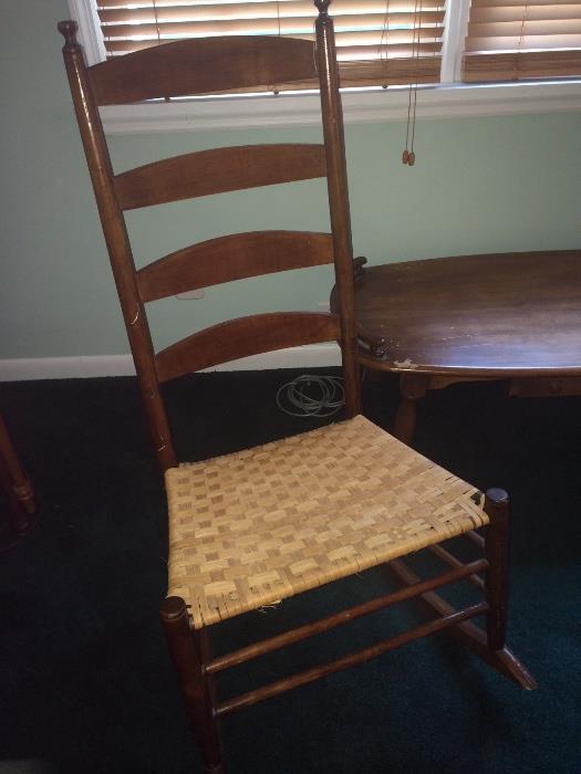 Ladder back walnut rocker, c. 1880. 41.5" height. Basket weave seat has been replaced. Trapezoid seat and round cylindrical front legs.