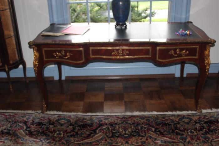 Bureau-Flat or Desk, leather top insert with outline gilt scroll mounted in ormolu with shell corners. 30" height and 67.5" width.