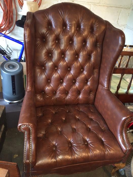 Wingback leather tufted side chair.