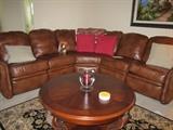 Bradington leather sofa sat in once or twice recliners at both ends.  Kincaid round coffee table, area carpet