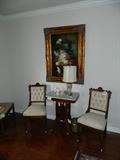 Pair of Eastlake Victorian side chairs and marble top table.  All with original casters.  Re-upholstered in proper fabric in late 20th C.