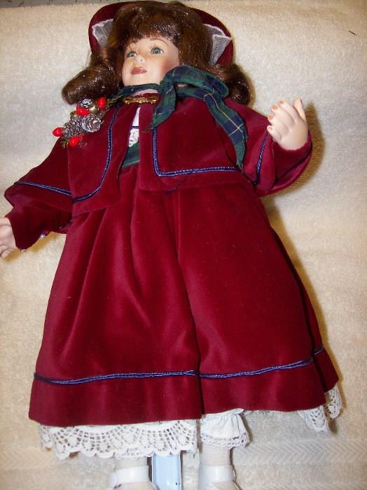 Porcelain Doll dressed in a Red Velvet Outfit and Bonnet