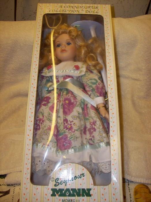 Porcelain doll with stand in pristine condition in collector's box