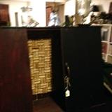 Black handcrafted liquor cabinet with wine cork back wall. Unique piece.