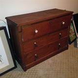 Late 1800's dresser. The original knobs were missing replaced on the top drawer but this piece has been used as a base for a TV in the past. When you remove the top drawer, there is a shelf built in and holes in the back for cords. The top drawer has dividers and hooks to hang on the wall as a shelf. Very cool piece!