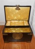 Black Asian style jewelry chest with brass fittings.