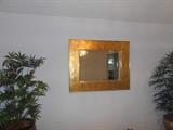 Beveled mirror beautifully framed in a wide floral gold frame.