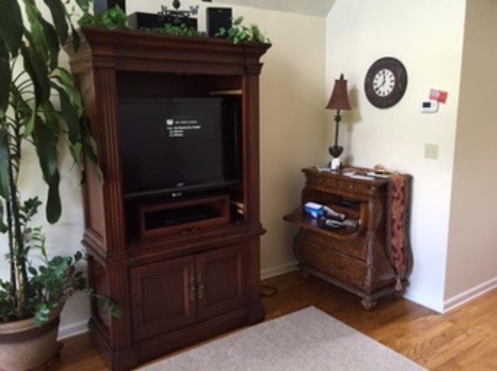 Nice heavy armoire. Door taken off for TV to fit, but can be put back on tracks. Sony surround system. Vizio TV. Dvd player. Lamp, Clock. Writing chest is sold.