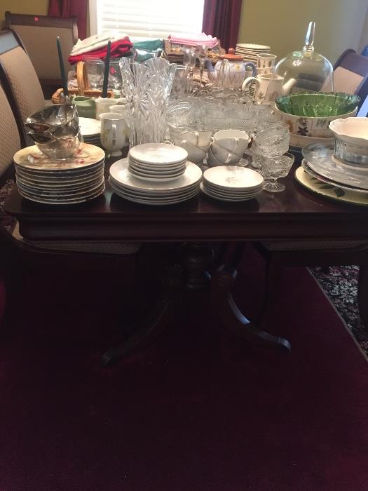 Dining room table and 8 chairs and two leaves. Tons of vintage glass and plates and china