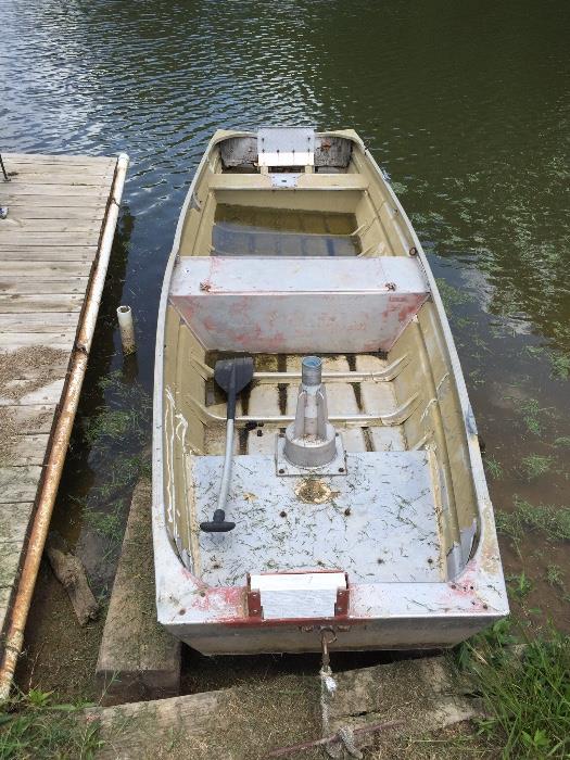 Old 70's fishing boat with trailer. Doesn't leak...that's just rain water on the far end.