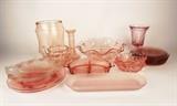 Item Description: A collection of eighteen pink pressed glass depression ware items including plates, scalloped bowls, a canister jar, glass, cream pitcher and more.
