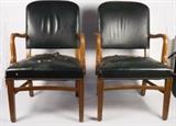 Item Description: A pair of Gunlock office executive arm chairs featuring green leather upholstered back and seat with wooden carved arms and legs.
