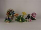 Item Description: An array of five vintage Capodimonte and Italian porcelain floral figurines including two basket bouquets, a rose candle holder, a napkin ring embellished with flowers and more all boasting delicate intricately sculpted petals. Three pieces are marked with Capopdimonte marker mark to bottom. 
