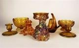 Item Description: An assortment of eight amber toned depression ware and Carnival glass items including a lovely Carnival glass Lady figurine, a pedestal dish, a pair of amber glass candlestick holders and more.
