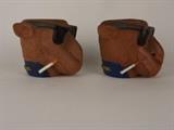 Item Description: A fun pair of vintage Camel cigarette , smooth character, drink Koozies shaped like the iconic Joe Camel wearing a pair of dark sunglasses with a cigarette in his mouth. 

