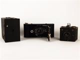 Item Description: Three cool vintage Eastman Kodak Co. cameras including a. No. 2A folding cartridge Hawkeye, Model B camera, a No. 2A Brownie with aluminum body box camera, and a Brownie Flash six-20.
