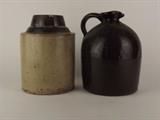 Item Description: Two antique primitive brown pottery items, a beehive style jug with handle and spout and a rustic brown and tan jar.
