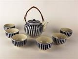 Item Description: A lovely vintage tea set in white with cobalt blue stripes. The set includes a lidded teapot with rattan handle and six matching tea cups.
