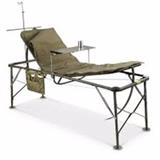 Item Description: A folding adjustable military field hospital patient bed with aluminum alloy frame, includes one pad mattress, a personal affects bag, an aluminum insect bar and an aluminum service stand.
