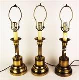 Item Description: Three lovely brass toned candle stick style table lamps with ridged details from the US House of Representatives, Office of the Clerk.
