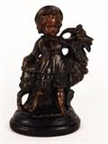 Item Description: A vintage ceramic statue of a young boy and a goat with a bronze toned glaze.
