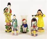 Item Description: A wonderful collection of Asian porcelain and ceramic figurines including a little girl dressed in yellow stamped "Yamaka, made in Occupied Japan" on bottom, a bud vase with an adorable bell hop stamped "Japan" on bottom, two Chinese figures dressed in colorful robes and a lovely figurine of an Asian woman standing atop a lily pad.
