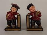 Item Description: A nice pair of vintage Redware bookends depicting an Asian boy and girl each leaning on black books with gold colored pages.

