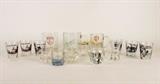 Item Description: An assortment of vintage glass barware collectables including seven funny shot glasses with pictures, three shot glasses that look like tiny beer mugs, a Red Bull Inn whiskey glass and much more.
