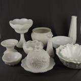 Item Description: A beautiful assortment of twelve pieces of vintage milk glass items including a footed scalloped edge bowl with a grape vine design, two lovely bud vases, two scalloped edged bowls made to look like flowers, a dome lidded butter or cheese dish with rose design on dome and along edge of dish and much more.
