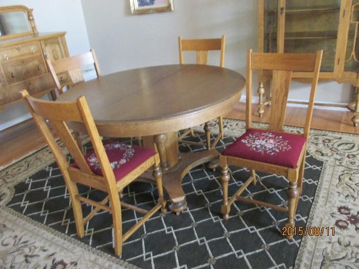 Beautiful Round Table (has leaf that goes with it in the hall closet), Chairs have needlepoint seats.