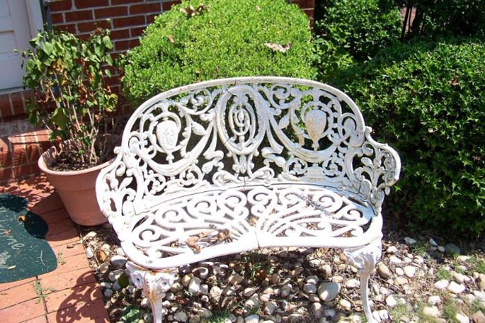 Iron garden bench in back yard